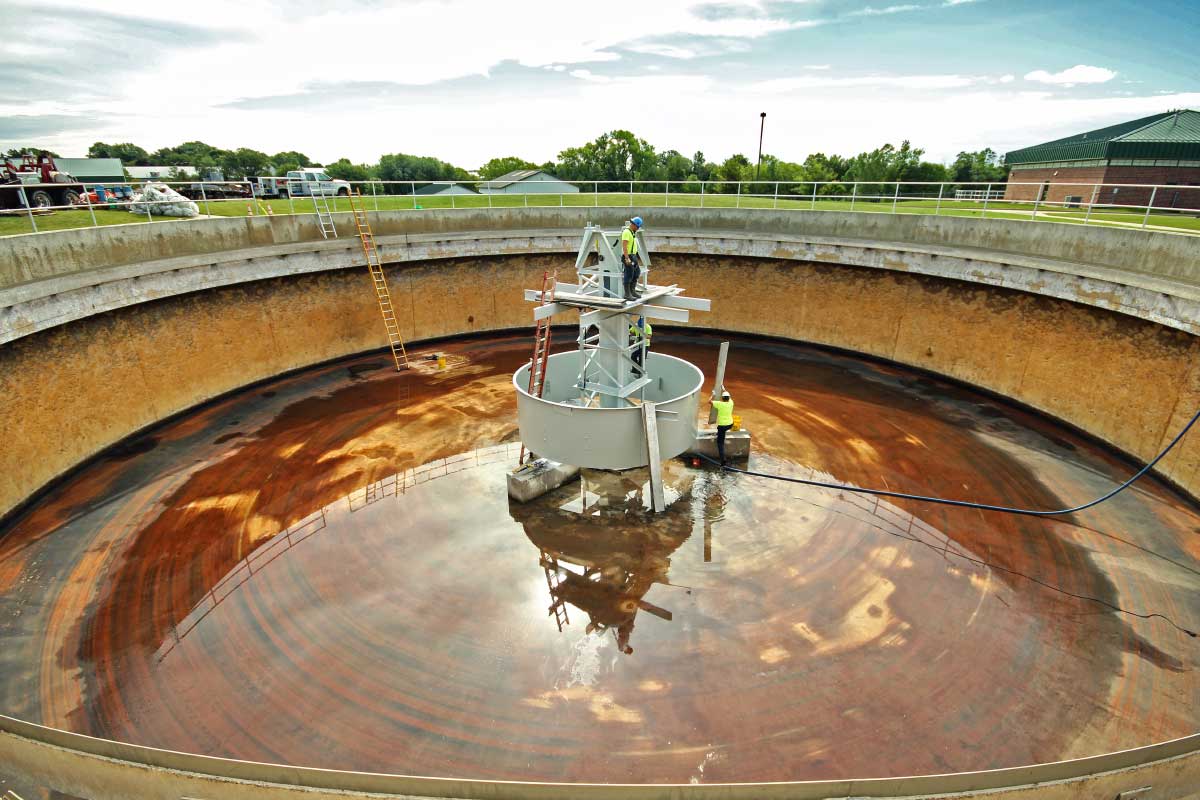 crane_employees_servicing_wastewater_pool_system