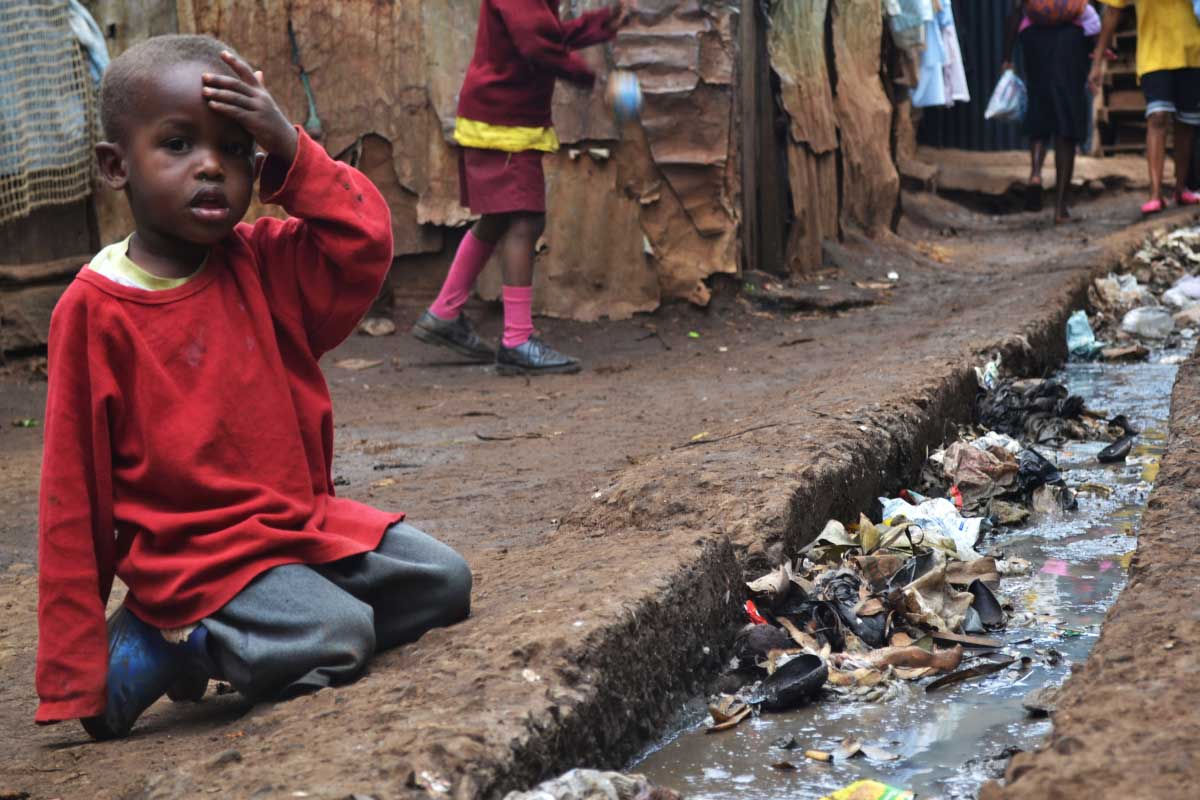 young_boy_next_to_contaminated_water